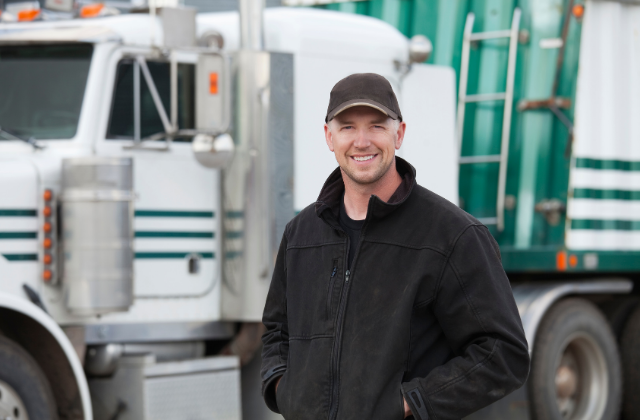 Man standing in front of white semi truck with green stripes